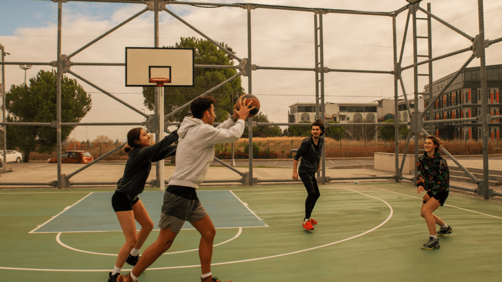 A group of people playing basketball