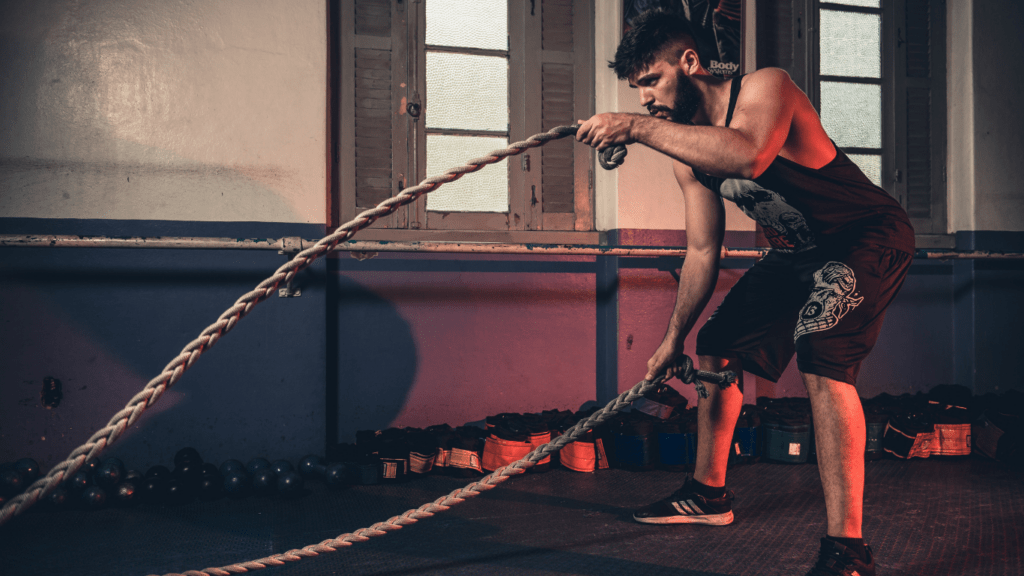A person is pulling a rope in a gym