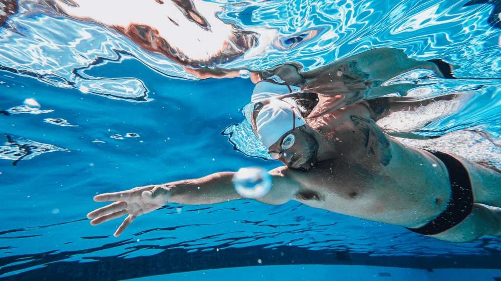 A person swims underwater in a pool