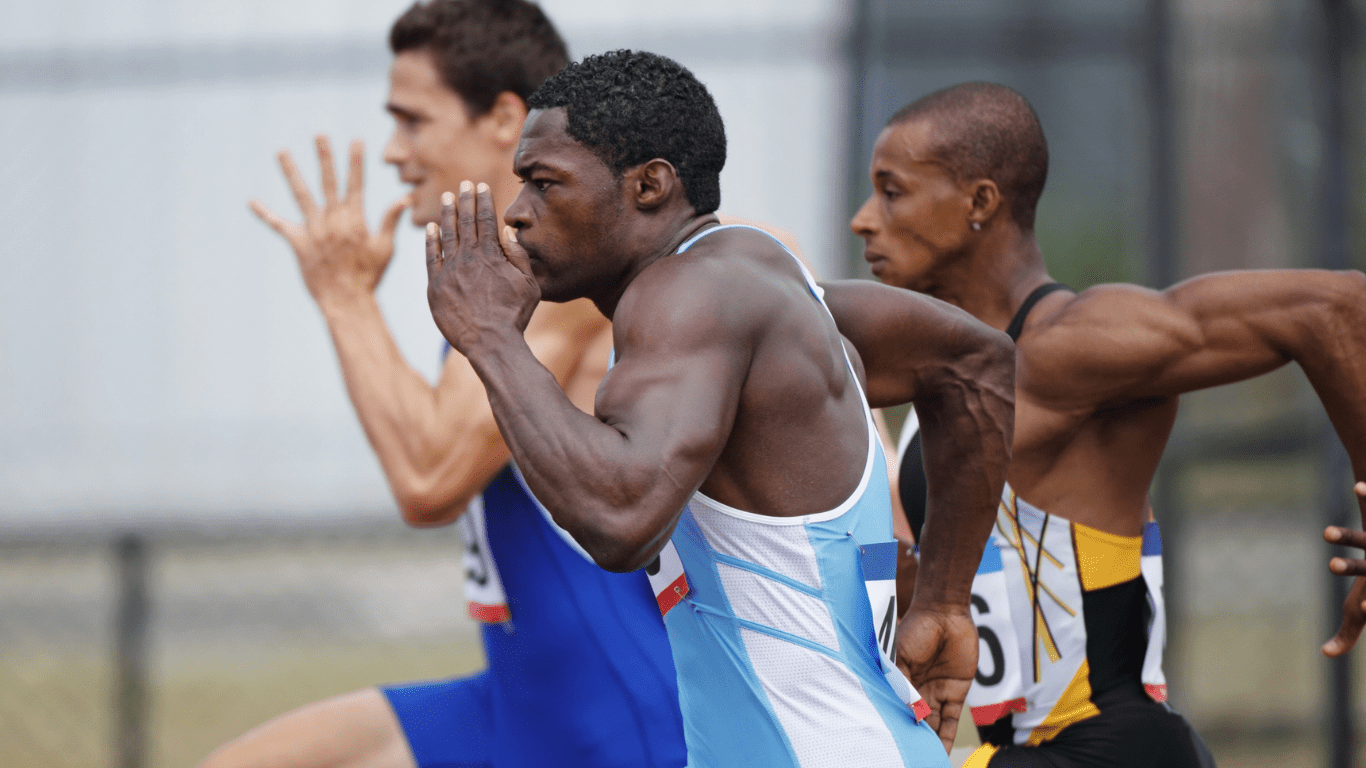 a group of athletes running on a track