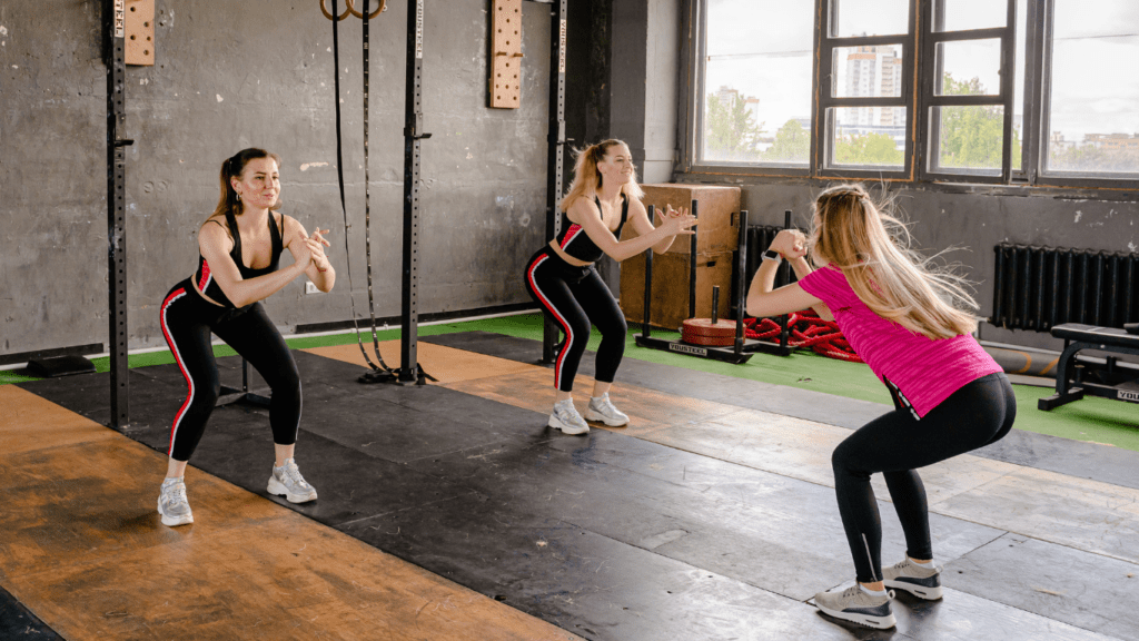 a group of people doing zumba in an empty room