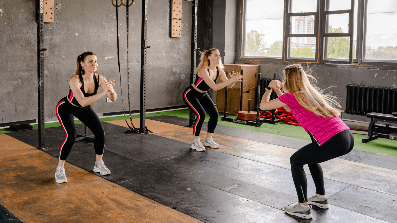 a group of people doing zumba in an empty room