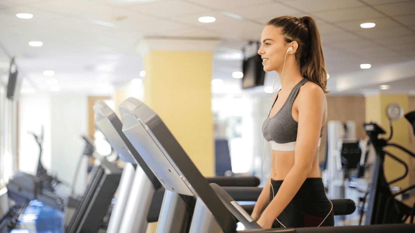 a person running on a treadmill in a gym