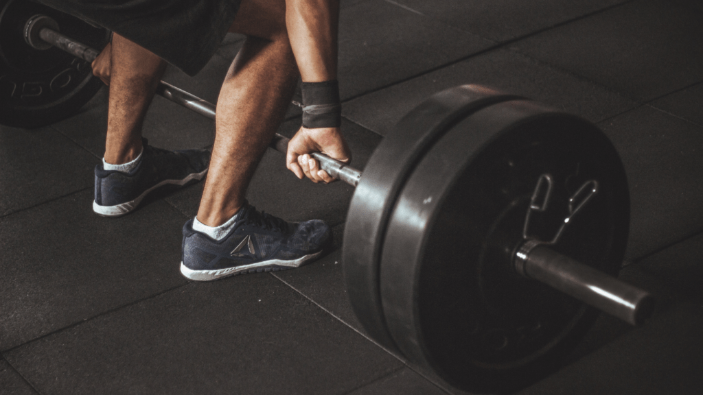 A person lifting a barbell in a gym