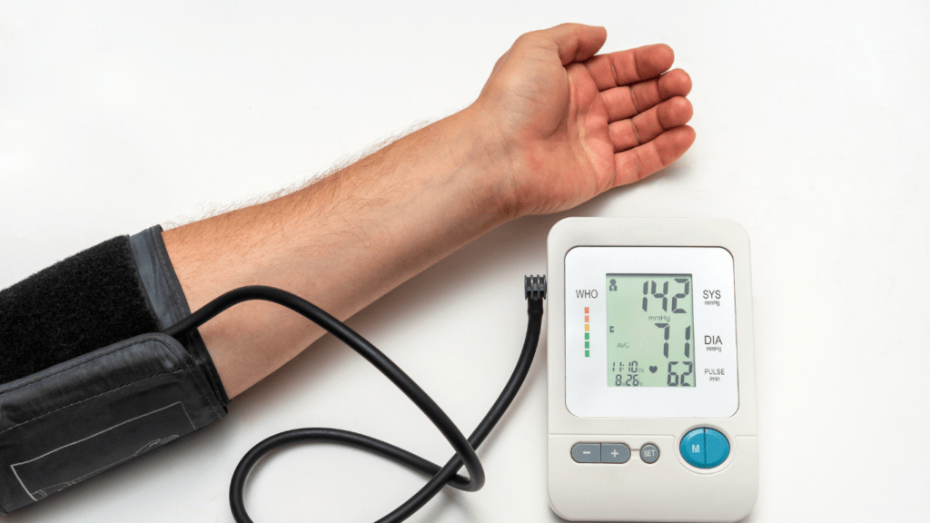 A hand with a blood pressure monitor