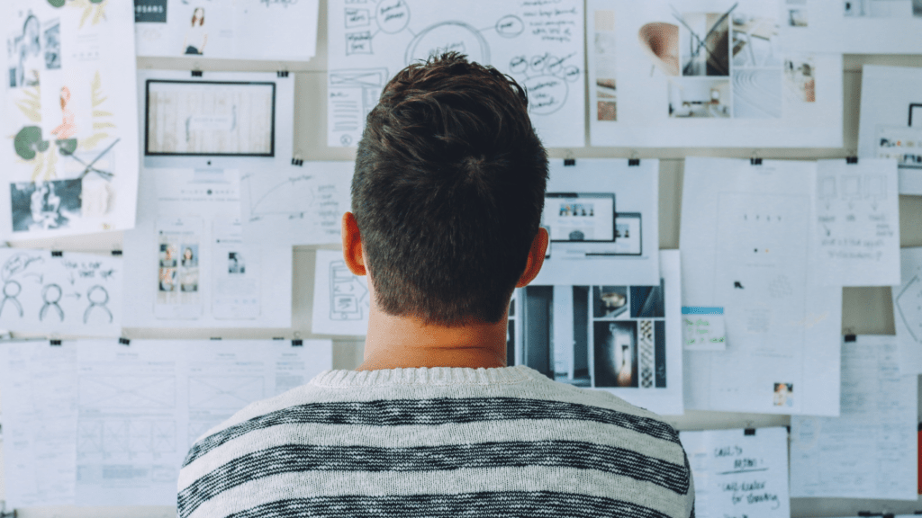 a person standing in front of a whiteboard