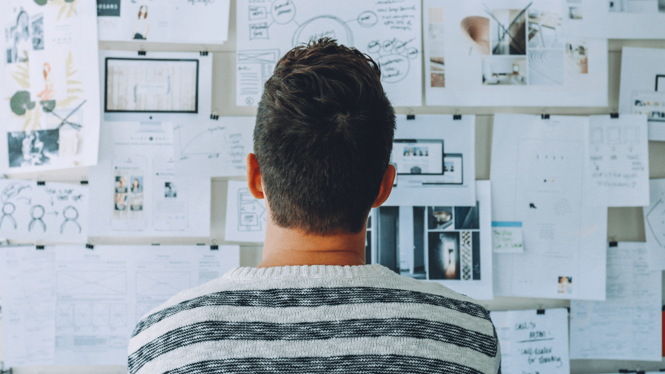 a person standing in front of a whiteboard