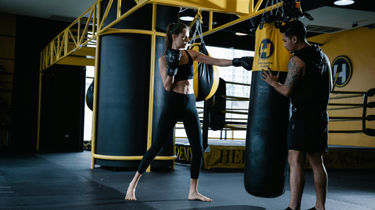 A person punching a punching bag in a gym