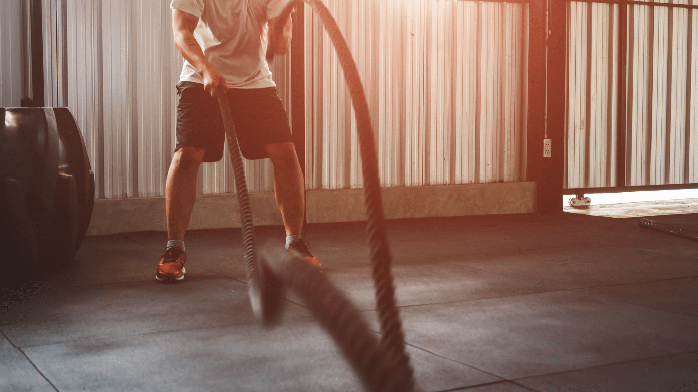 A person is pulling a rope in a gym