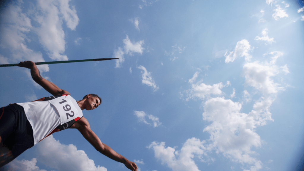 A pole vaulter holding a pole in the air