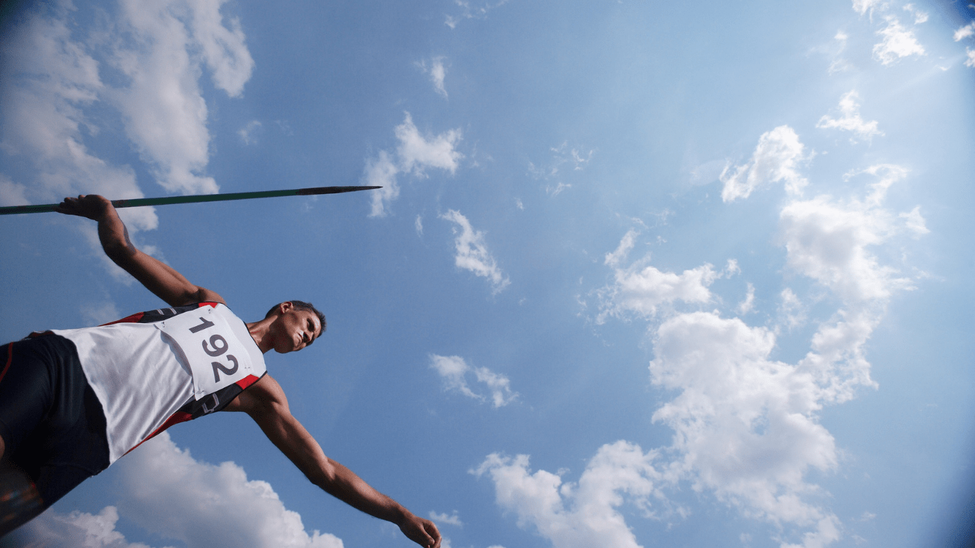 A pole vaulter holding a pole in the air
