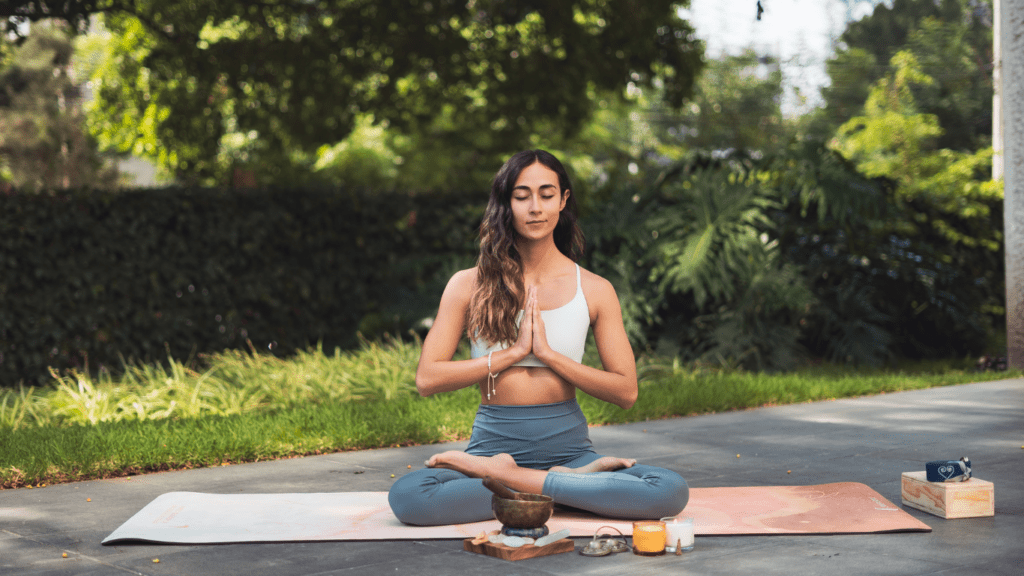 a person meditating in a yoga pose on a mat
