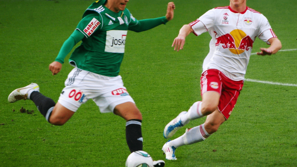 two people playing soccer on a field
