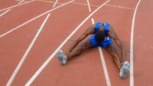 a person sitting on the ground with their legs up in the air