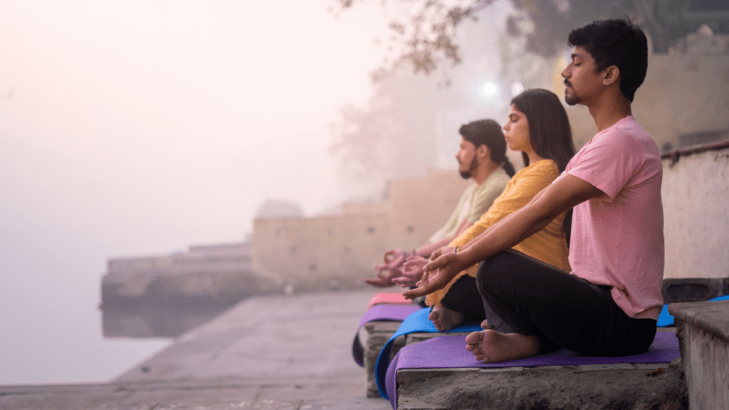 three person doing yoga