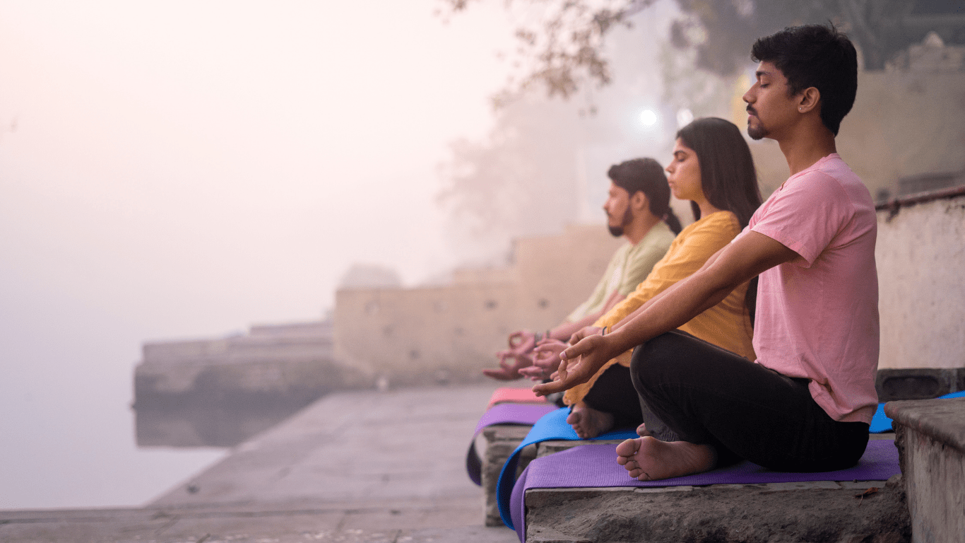three person doing yoga