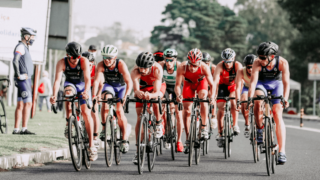 a group of cyclists are riding down a road