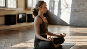 a person sitting on a bed doing yoga