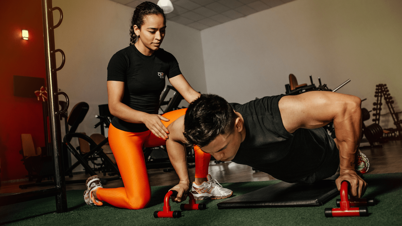 Two people doing pilates exercises in a gym