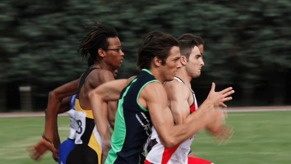 a group of athletes running on a track