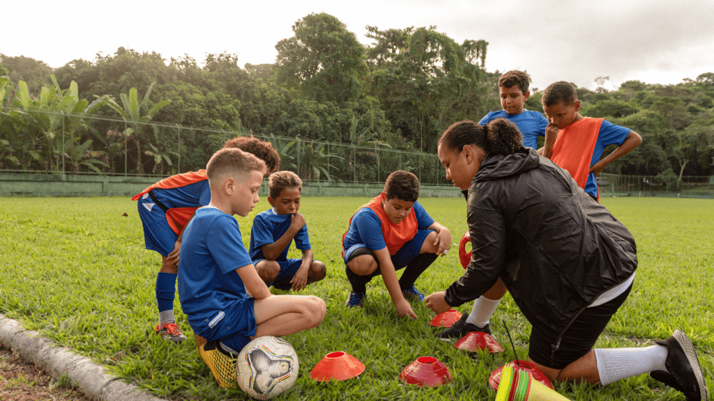 a group of children playing soccer on a field