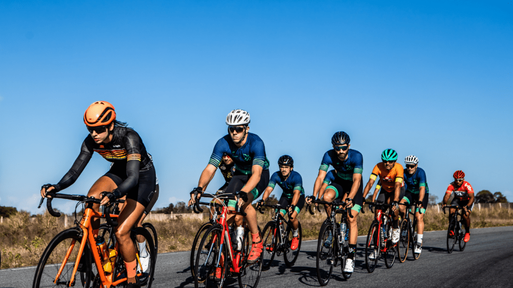 a group of cyclists are riding down a road