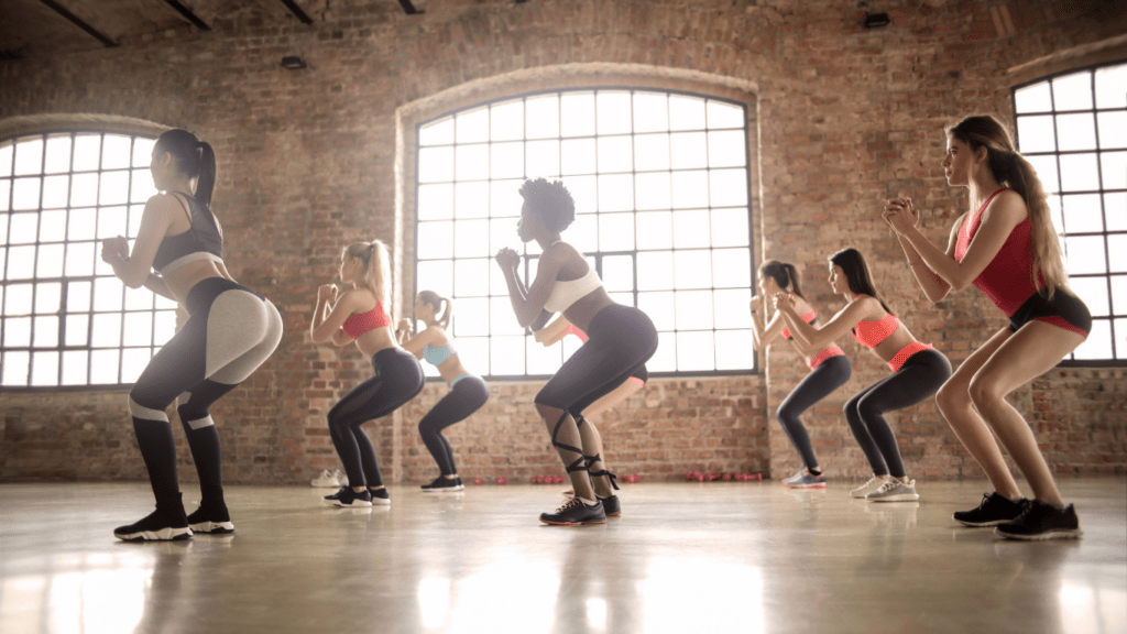 a group of people doing zumba in an empty room