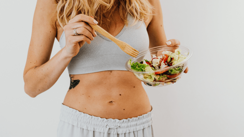 a person eating a salad with a fork