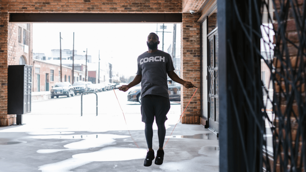 a person is jumping in the air with a skipping rope
