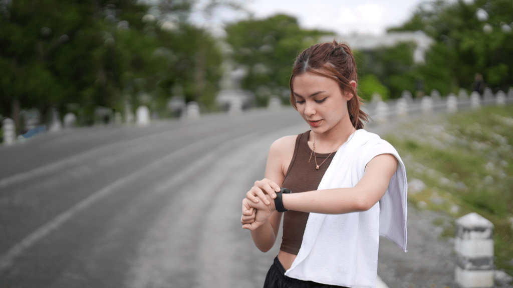 a person is standing on the side of the road looking at their watch