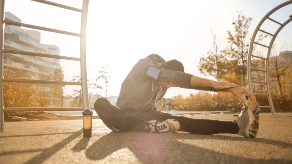 a person sitting on the ground with their legs up in the air