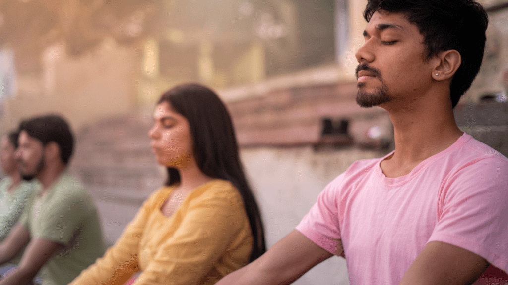 three person doing yoga