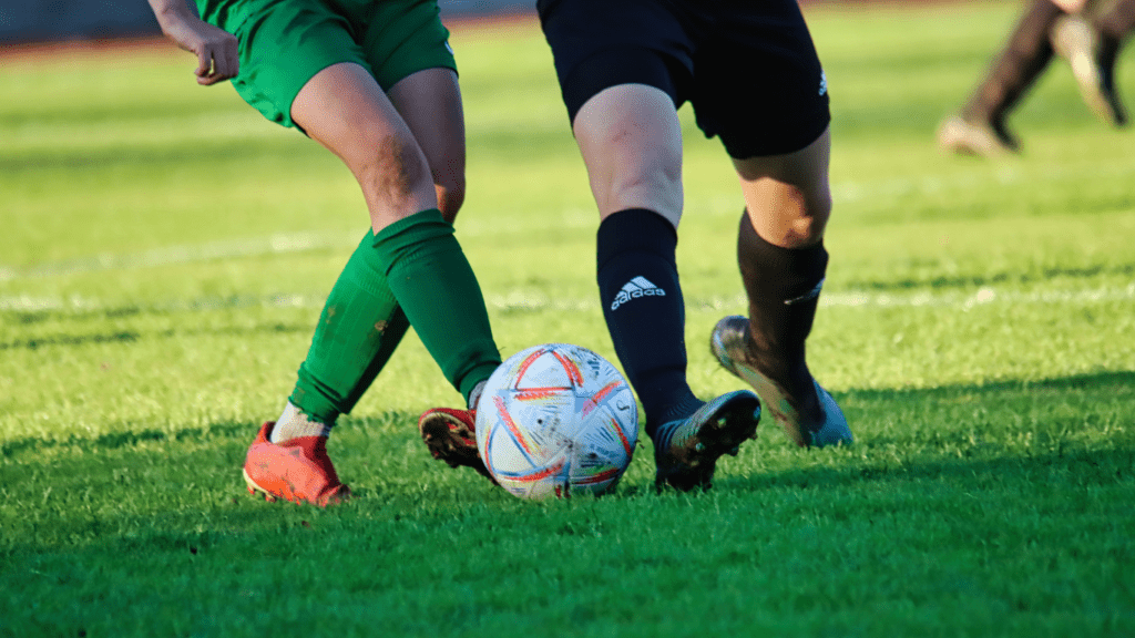 two people playing soccer on a field